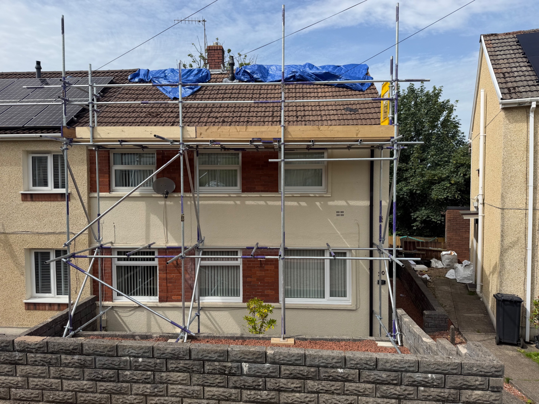 Domestic scaffold with temporary roof protection on a semi-detached house in Swansea by All Heights Wales Ltd.