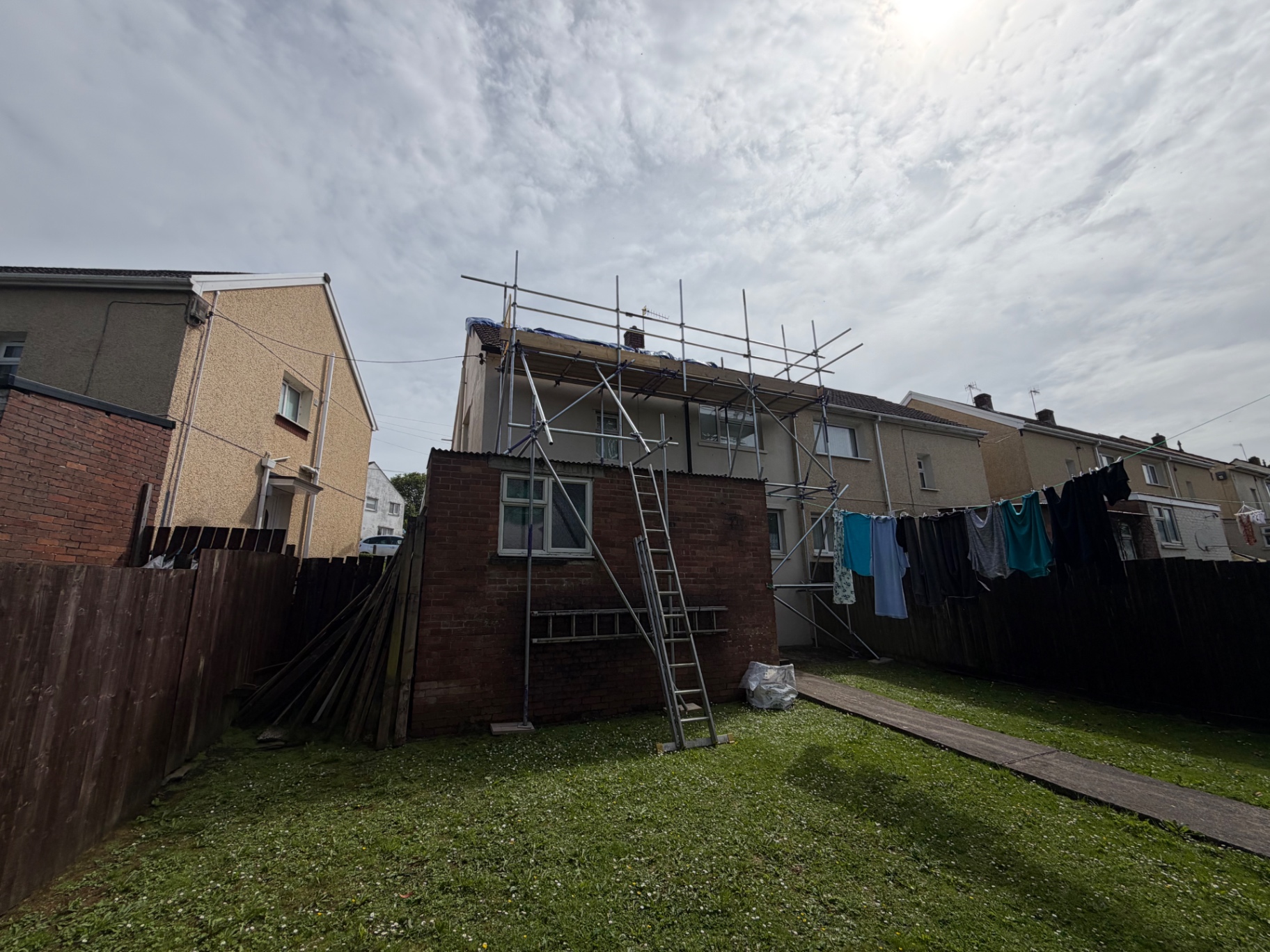 Rear scaffold with chimney access for roof repair in Llanelli by All Heights Wales Ltd.